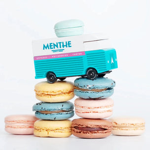 Candylab wooden toy Menthe Macaron van sitting on top of a pile of macaron | Conscious Craft