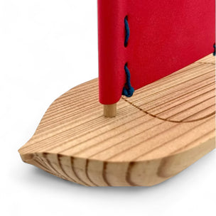 Close-up of a wooden product with a red top on a white background