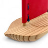 Close-up of a wooden product with a red top on a white background