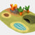 Felt play mat with a dragon and carrots on a white background