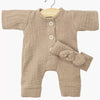 Beige Minikane romper with matching hat on a hanger against a white background