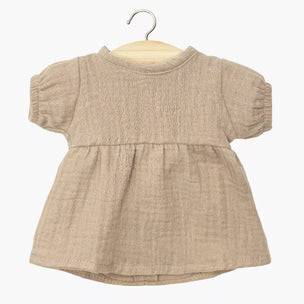 Beige minikane baby dress on a hanger against a white background
