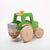Dynamiko green wooden Tractor with ballast | Image © Conscious Craft