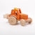 Dynamiko wooden bucket on orange tractor | Image © Conscious Craft