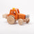 Dynamiko wooden orange tractor with ballast and bucket  | Image © Conscious Craft