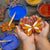 Colourful wooden decorations made using  the Nature Craft Paint Kit from Natural Earth Paint