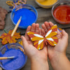 Colourful wooden decorations made using  the Nature Craft Paint Kit from Natural Earth Paint