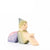 Eric & Albert wooden toy fairy in green sitting on the ground with pinky purple wings | © Conscious Craft