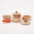 Set of wooden toy cookware with orange handles and lids on a white background