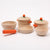 Set of wooden toy cookware with orange handles on a white background