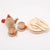 Wooden toy tea set with teapot, cups, and plates on a white background