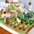 Toy farm set with animals and vegetables on a green felt surface