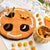 Round felt board with a bee and honeycomb design, surrounded by small round felt pieces on a white surface.