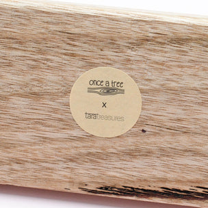 Wooden product with a 'once a tree' and 'taratreasures' label.