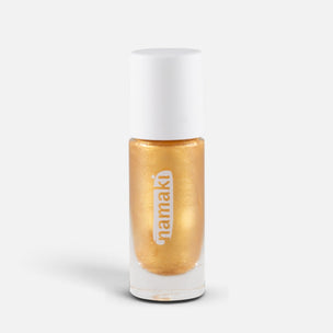 A bottle of Namaki metallic gold nail polish with a white cap, shown on a clean light gray background.
