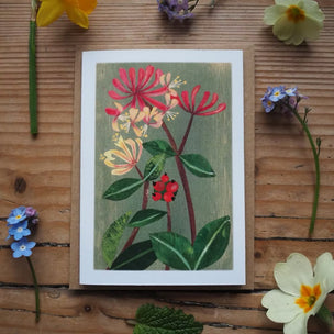 Floral illustration on a wooden surface with real flowers around