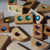 Wooden geometric blocks with colored gems on a neutral background