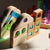 Wooden puzzle with colorful beads on a light fabric background