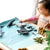 Child playing with toy sea creatures on a felt play mat