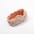Floral-patterned Maileg baby bassinet on a white background