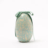 Decorative Maileg egg with a pattern of small animals and a green ribbon on a white background