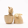 Small Maileg rabbit toy inside a decorative box on a white background