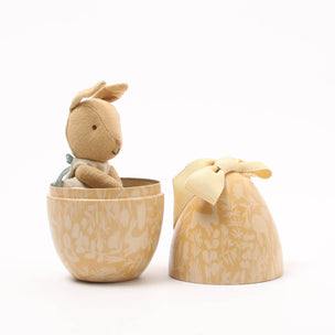 Toy Maileg rabbit in a wooden cup with matching packaging on a white background