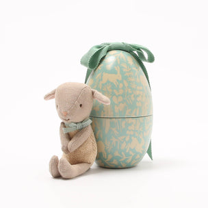 Small Maileg  lamb toy with a decorative egg on a white background
