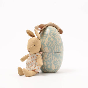 Small Maileg rabbit toy with a decorative egg-shaped container on a white background