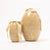 Two decorative Maileg egg-shaped containers with floral patterns and ribbons on a white background