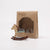 Wooden rocking horse toy next to its packaging on a white background