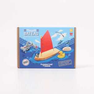 Toy boat set packaging with a sailboat illustration on a blue background