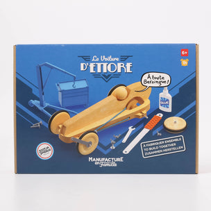 Box for a wooden toy car kit with tools and glue, featuring branding and product details.