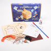 Wooden exploration lamp kit with components and instructions on a white background
