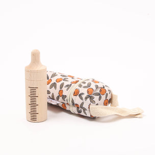Baby bottle, comb, and brush set with floral pattern on a white background