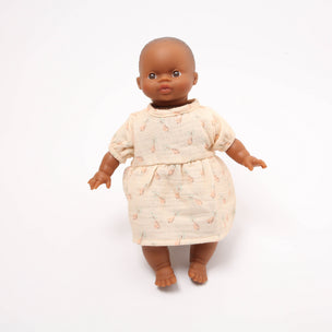 Doll wearing a patterned dress on a white background