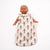 Baby doll wearing a floral patterned baby wrap on a white background