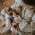 Child holding a baby doll with a bottle in a home setting