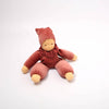 Stuffed toy in a pink outfit with a hood on a white background