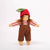 Small doll with a red hat, brown overalls, and striped shirt on a white background
