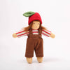 Small doll with a red hat, brown overalls, and striped shirt on a white background