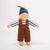Toy figure wearing a striped shirt, brown overalls, and a blue hat on a white background
