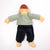 Doll wearing a green shirt and navy pants on a white background