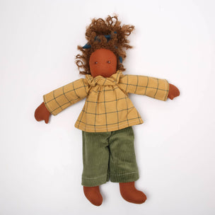 Textile doll with a yellow checkered shirt and green pants on a white background