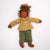 Textile doll with a yellow checkered shirt and green pants on a white background