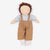 A handmade rag doll with curly brown hair, a beige face, a light blue-gray knit shirt, and brown corduroy overalls, laid flat on a white background.