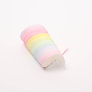 Pastel rainbow-colored wax sheet on a white background