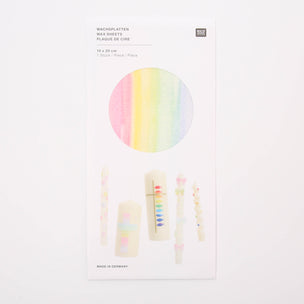 Packaging of rainbow-colored wax sheets with a white background