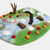 Felt play mat with animal figures and landscape elements on a white background