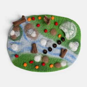 Felt play mat with animal figures and colorful elements on a white background